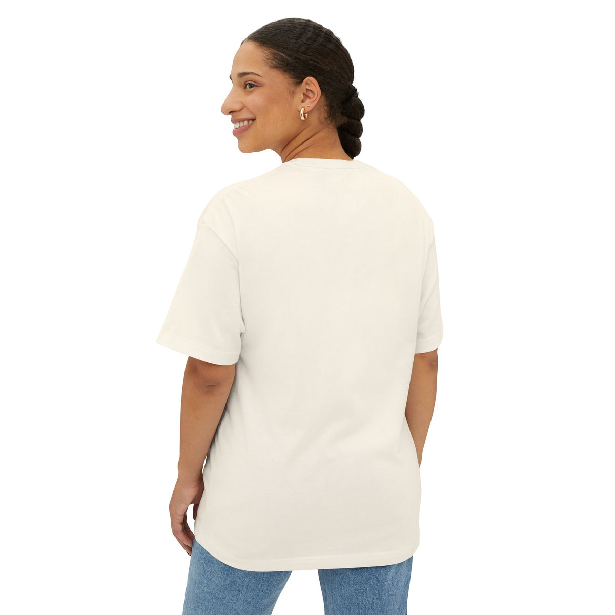 Woman wearing a beige t-shirt and blue jeans on a white background